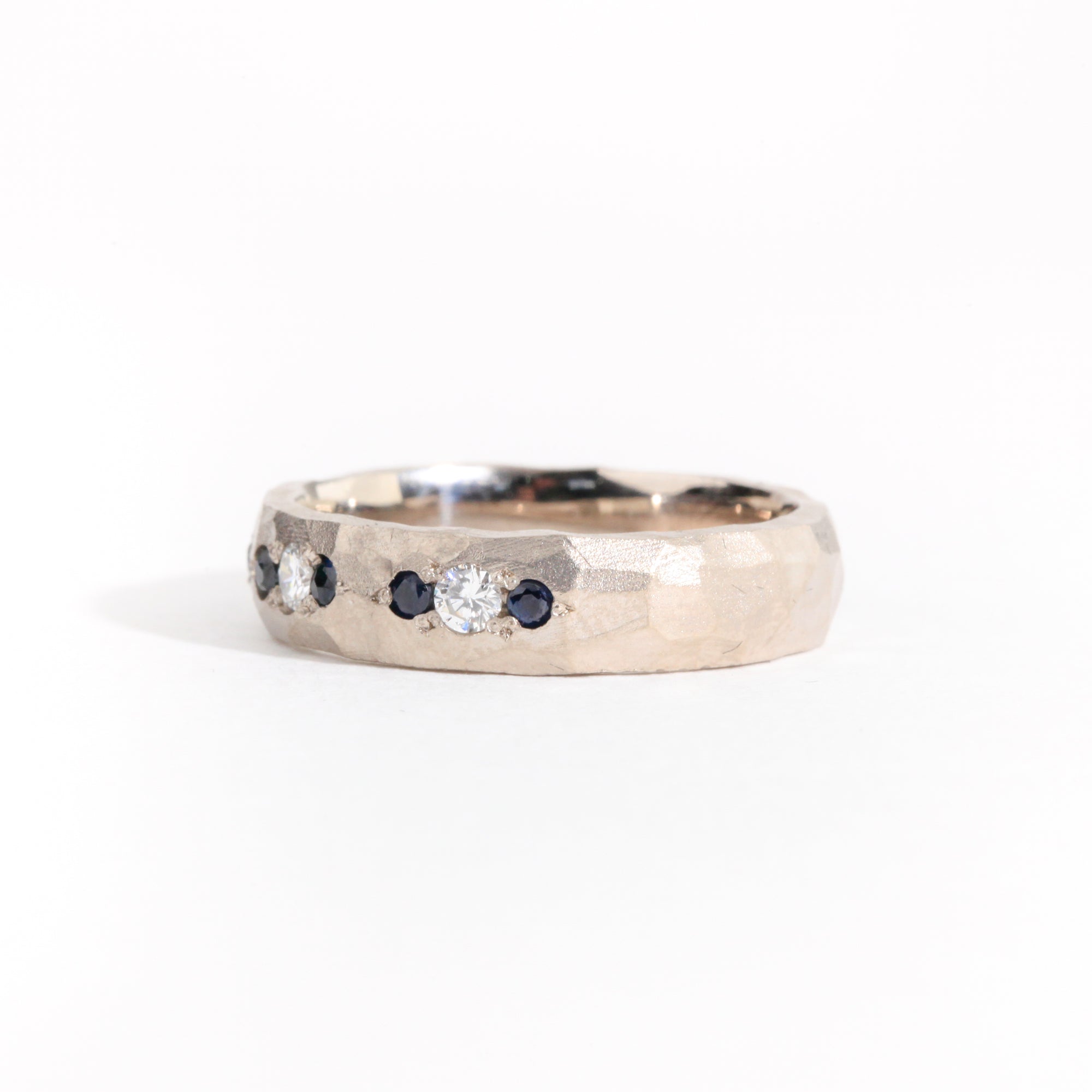 Hammered 18 carat white gold men's wedding band, set with ethically sourced Australian sapphires and conflict free diamonds.