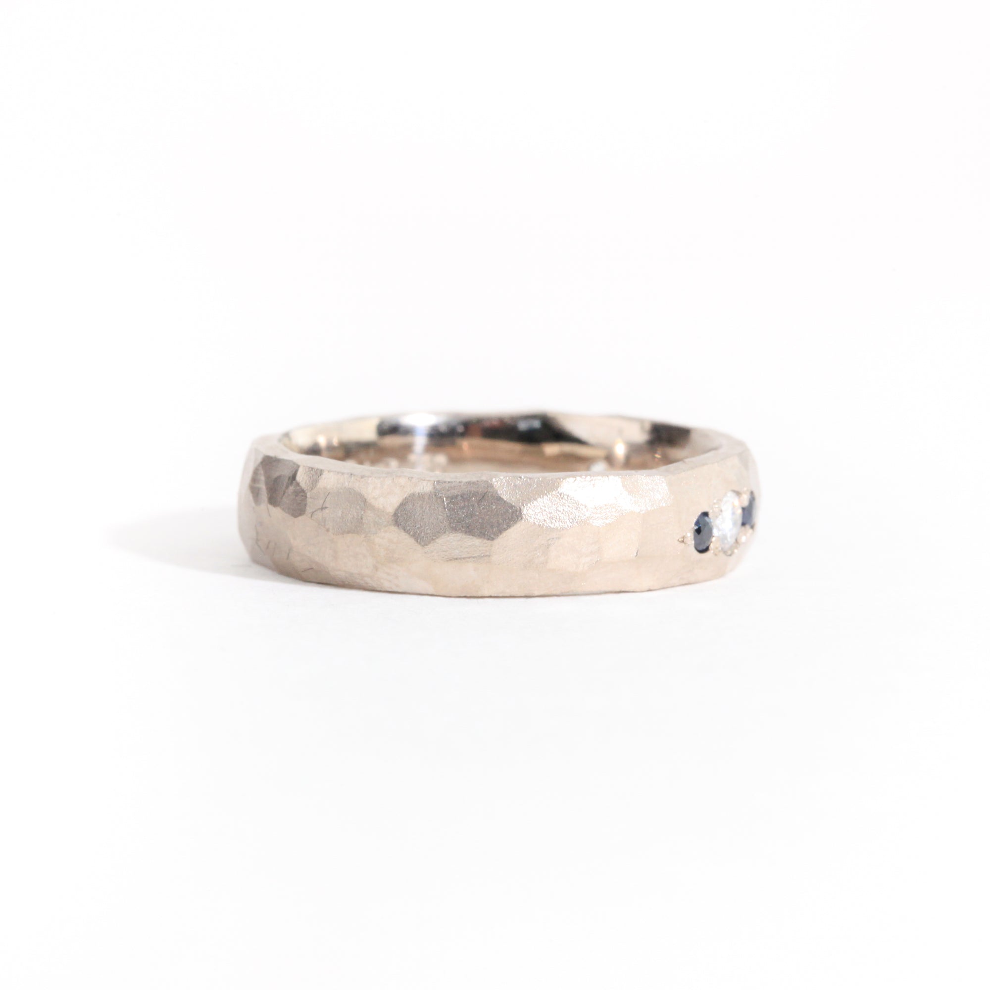 Hammered 18 carat white gold men's wedding band, set with ethically sourced Australian sapphires and conflict free diamonds.