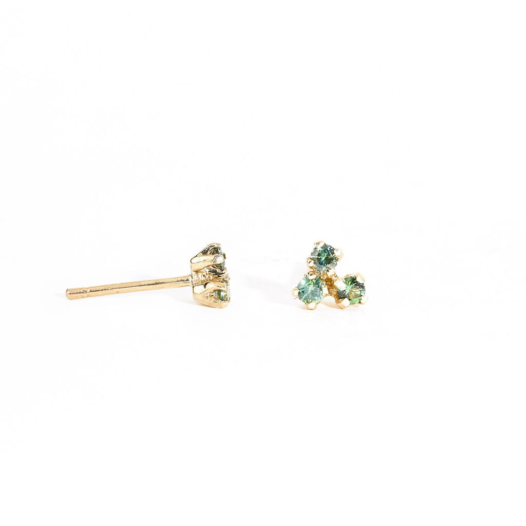 A pair of gold stud earrings featuring a mixture of blue, green ethically sourced Australian sapphires. Handmade in Melbourne by Black Finch Jewellery.