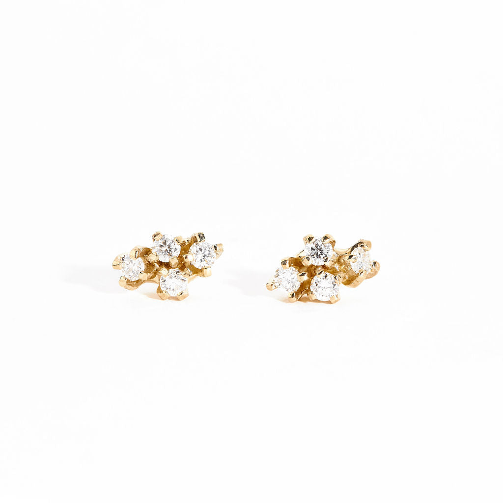 Pair of gold studs featuring four mixed white diamonds. Bespoke and handmade in Melbourne by Black Finch Jewellery.