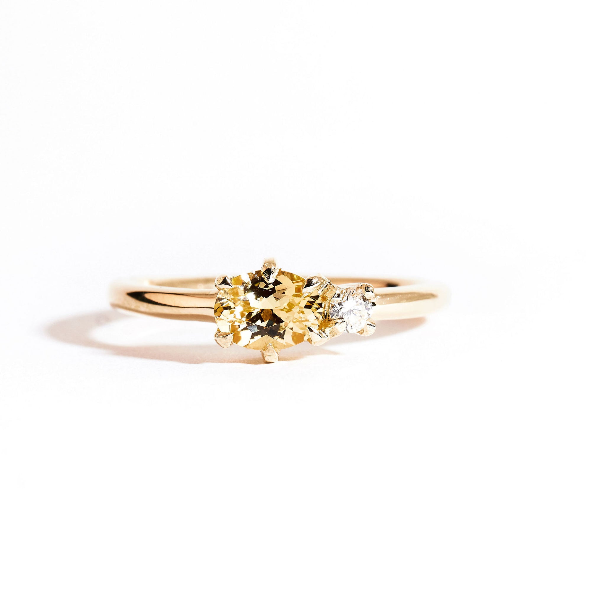Two stone ring crafted in 9ct yellow gold with yellow sapphire and white diamond. By black finch