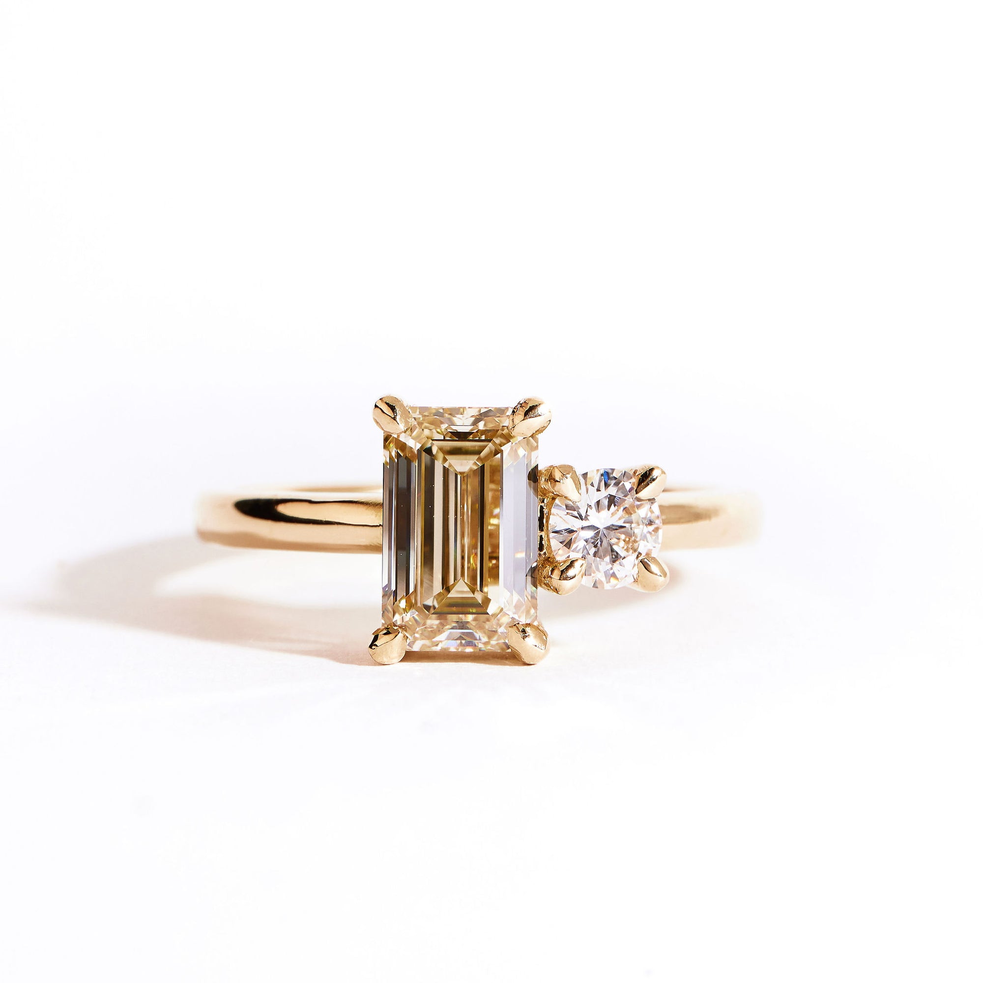 18 carat yellow gold ‘Toi et Moi’ ring, featuring one emerald cut yellow diamond, and one round white diamond.  