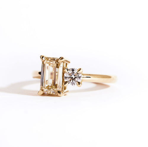 18 carat yellow gold ‘Toi et Moi’ ring, featuring one emerald cut yellow diamond, and one round white diamond.  