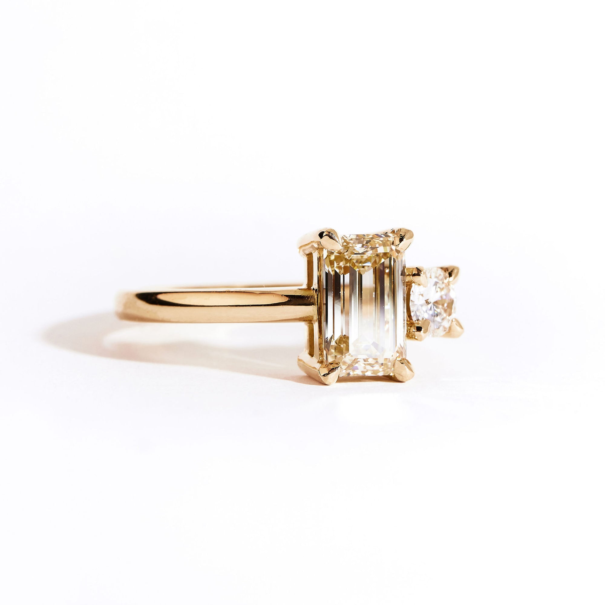 18 carat yellow gold ‘Toi et Moi’ ring, featuring one emerald cut yellow diamond, and one round white diamond.  