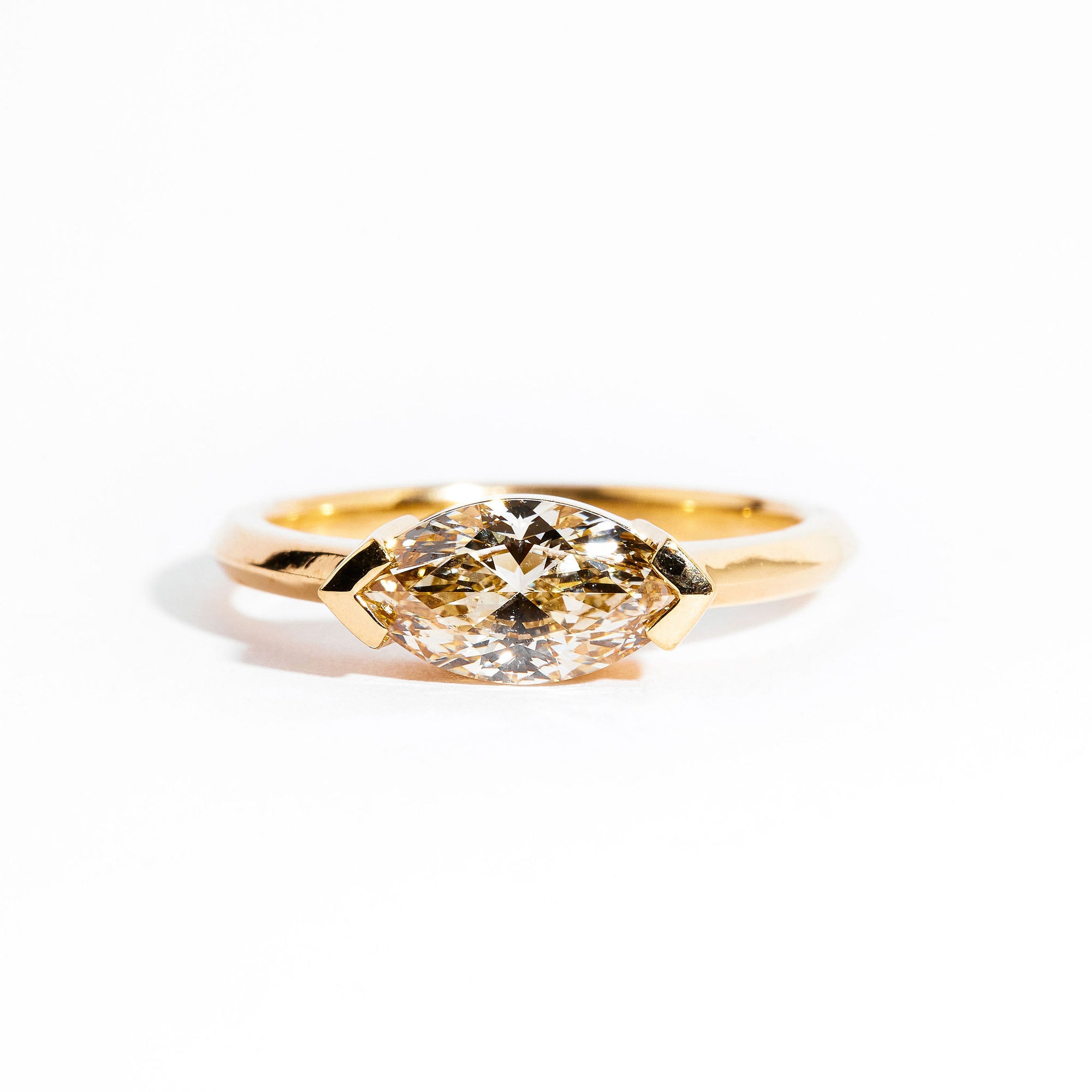 Hand crafted 18 carat yellow gold solitaire ring with  marquise champagne diamond. 