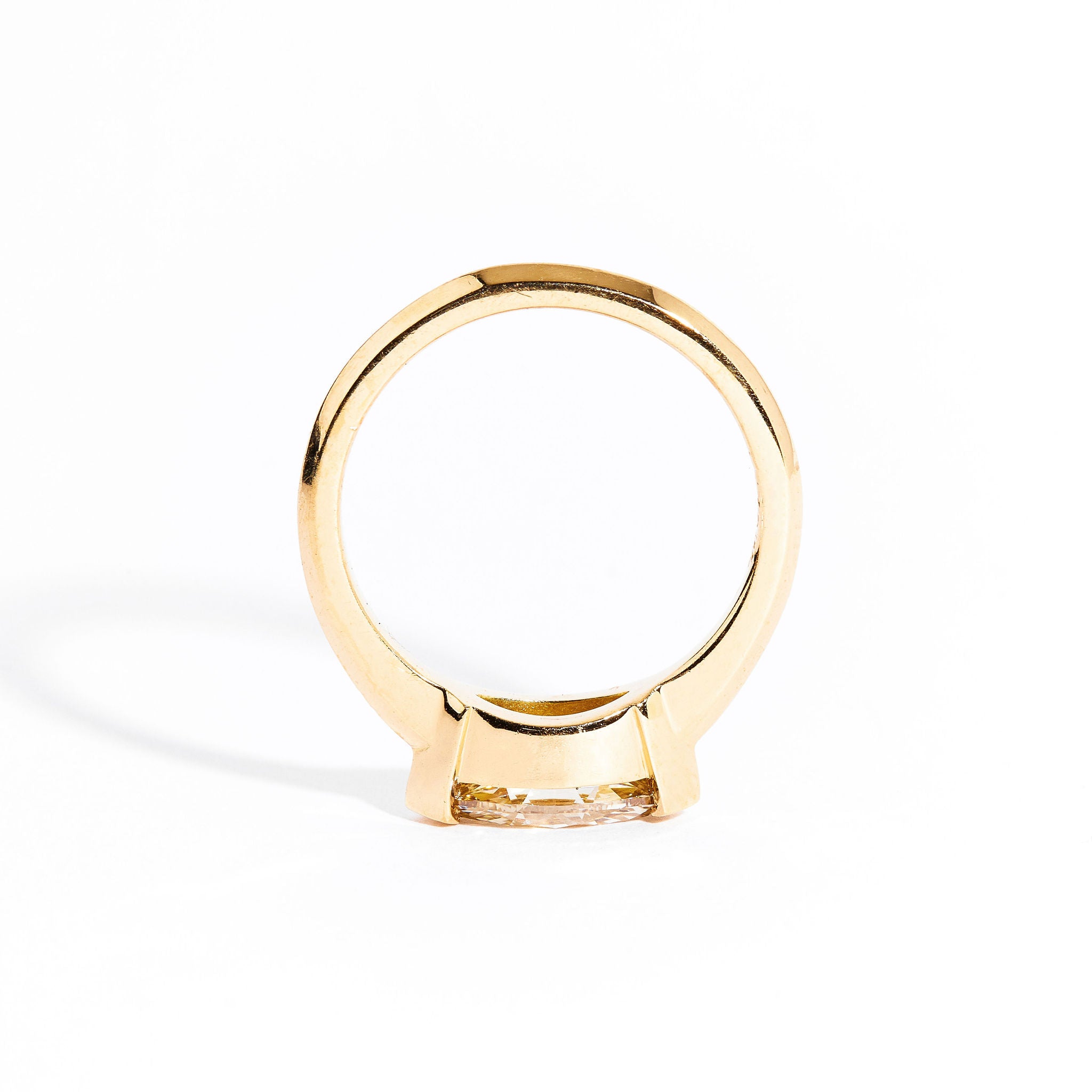 Hand crafted 18 carat yellow gold solitaire ring with marquise champagne diamond.