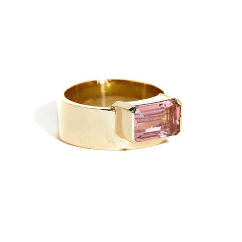  9 carat yellow gold, wide band ring, set with one emerald cut pink tourmaline. 