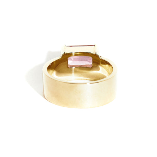  9 carat yellow gold, wide band ring, set with one emerald cut pink tourmaline. 