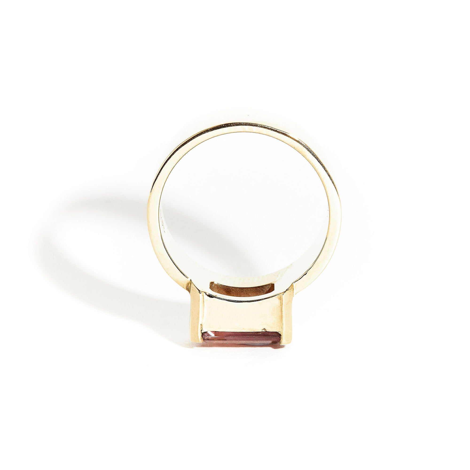  9 carat yellow gold, wide band ring, set with one emerald cut pink tourmaline. 
