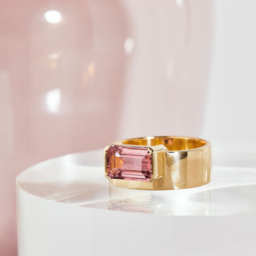  9 carat yellow gold, wide band ring, set with one emerald cut pink tourmaline. 
