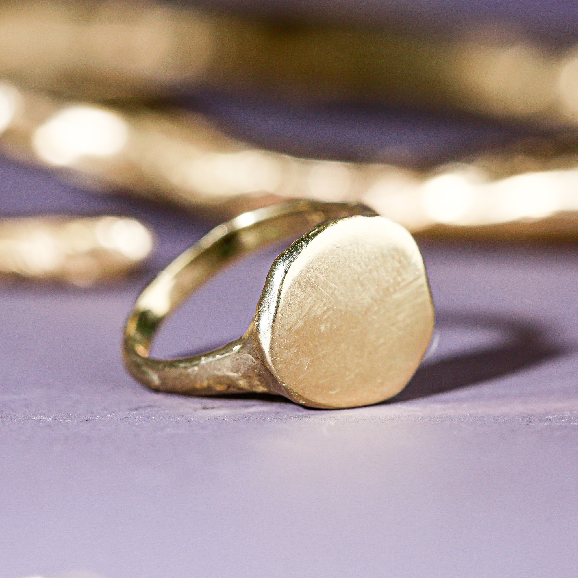 9 carat yellow gold round signet ring with a polished surface and soft matte band.