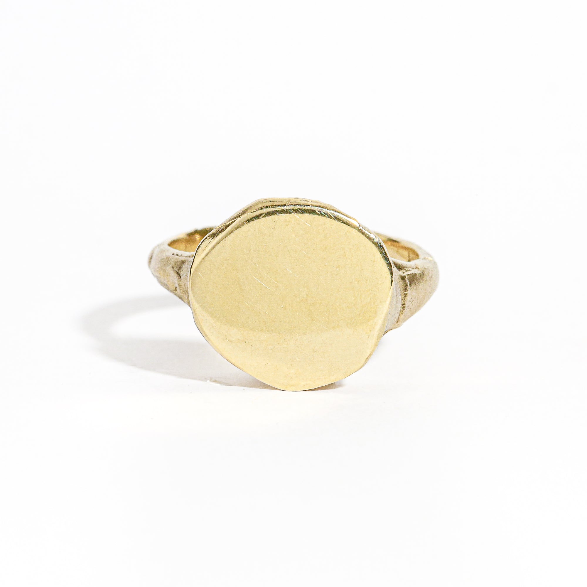 9 carat yellow gold round signet ring with a polished surface and soft matte band.