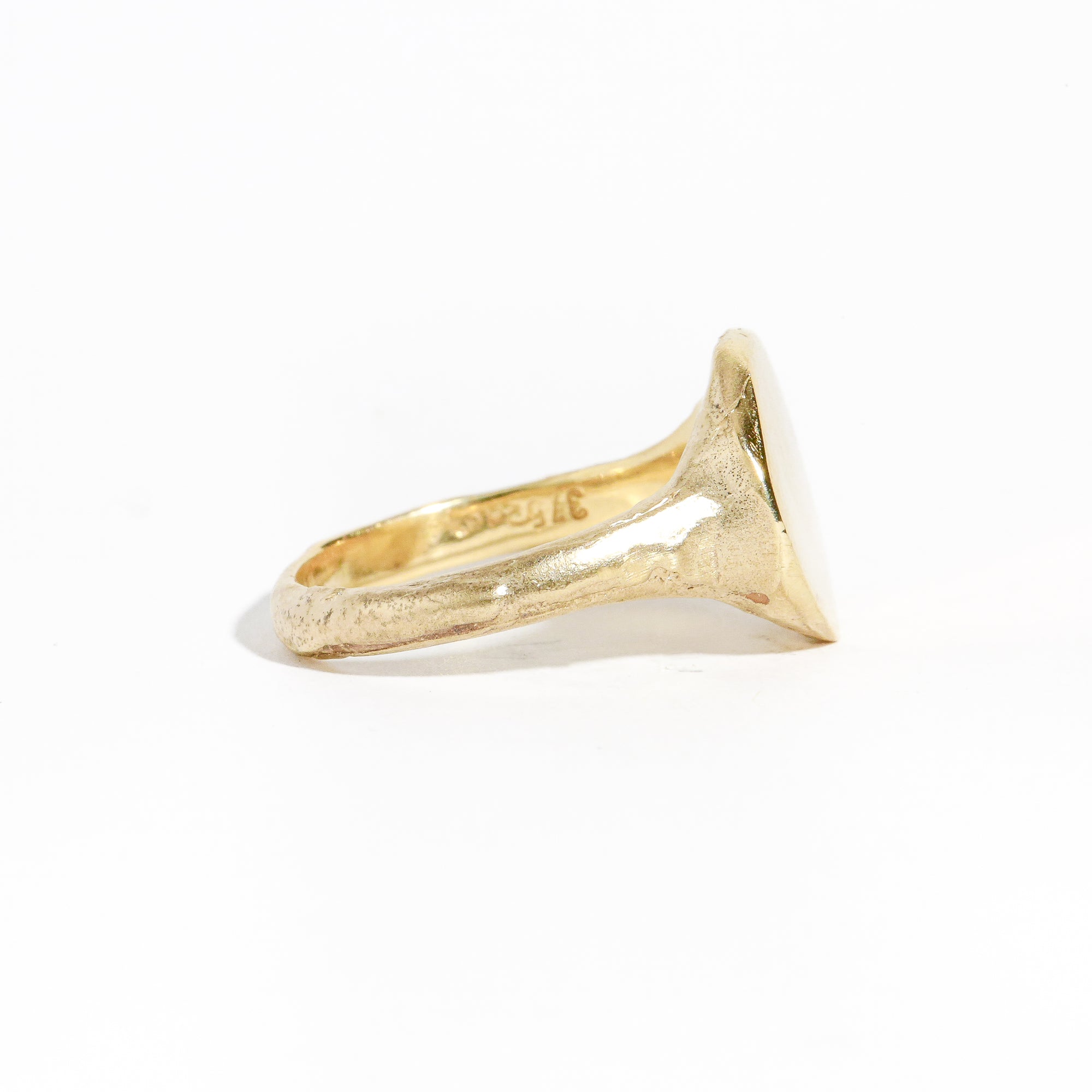 9 carat yellow gold round signet ring with a polished surface and soft matte band.