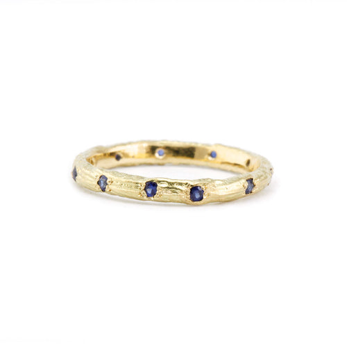 18 carat yellow gold cuttlefish cast wedding band, set with ten ethically sourced blue Australian sapphires.