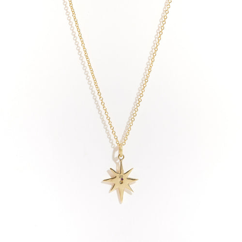 Bespoke handcrafted in Melbourne a 9ct yellow recycled, refined gold star shaped pendant with pink sapphire.
