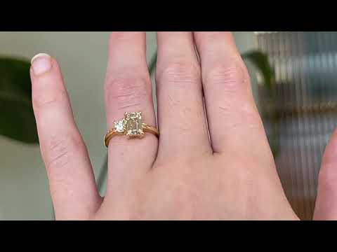 18 carat yellow gold ‘Toi et Moi’ ring, featuring one emerald cut yellow diamond, and one round white diamond, worn on the hand. 