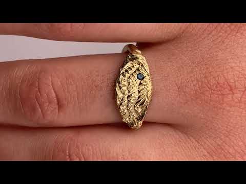 Gold ring featuring wing detailing and blue sapphire. Handmade and bespoke finish.