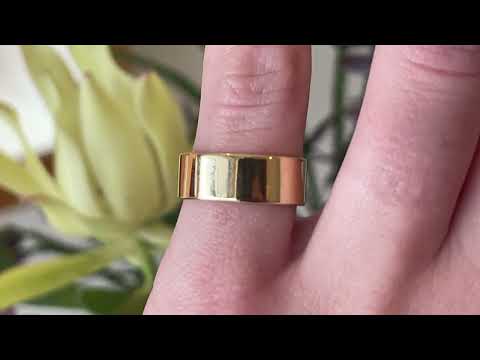Handmade cigar wedding band, shown in 18 carat yellow gold on the hand.