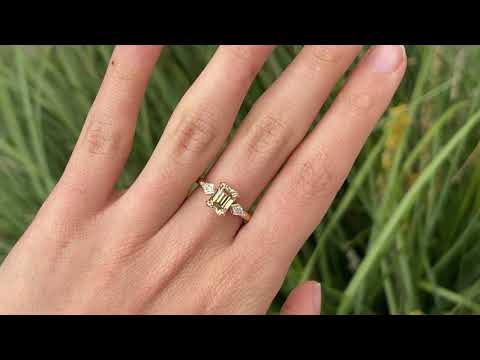 Video of Bespoke engagement ring with rectangular radiant cut champagne diamond surrounded by kite cut white diamonds. Recycled, refined gold custom and crafted in Melbourne by black Finch Jewellery